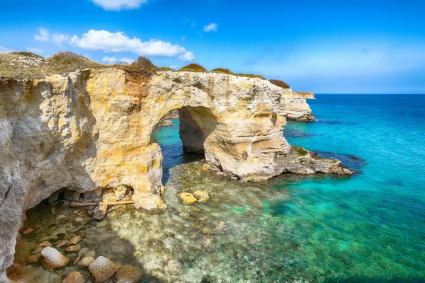 Picturesque seascape with cliffs, rocky arch at Torre Sant Andrea