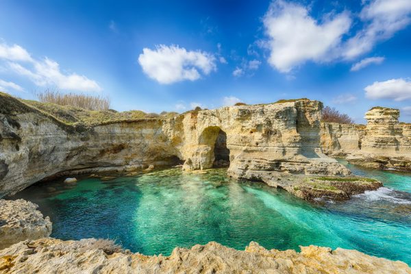 Picturesque seascape with cliffs, rocky arch at Torre Sant Andrea