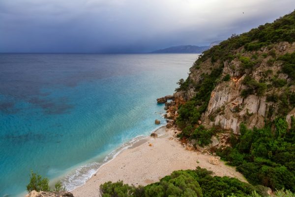 Sandy Beach on a rocky coast near Cala Gonone, Sardinia.